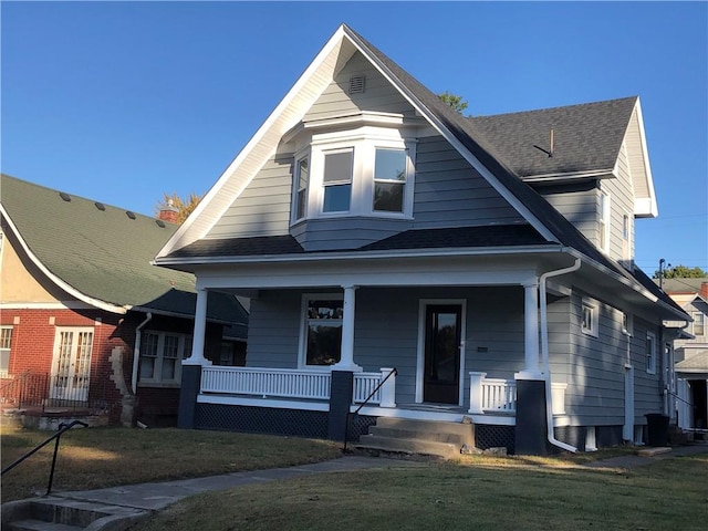 view of front of home with a front lawn and a porch