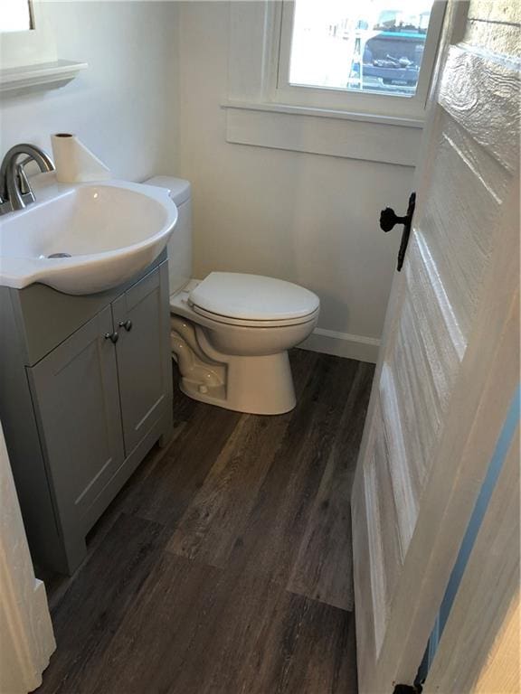 bathroom featuring vanity, wood-type flooring, and toilet