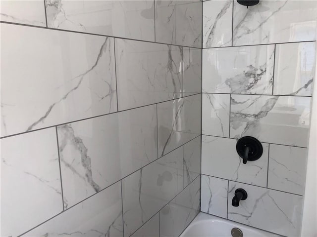 details with tiled shower / bath combo