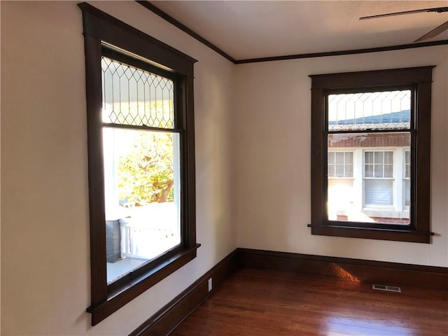 unfurnished room with crown molding and dark hardwood / wood-style flooring