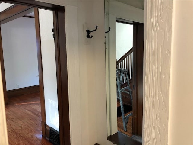 hallway with dark hardwood / wood-style flooring