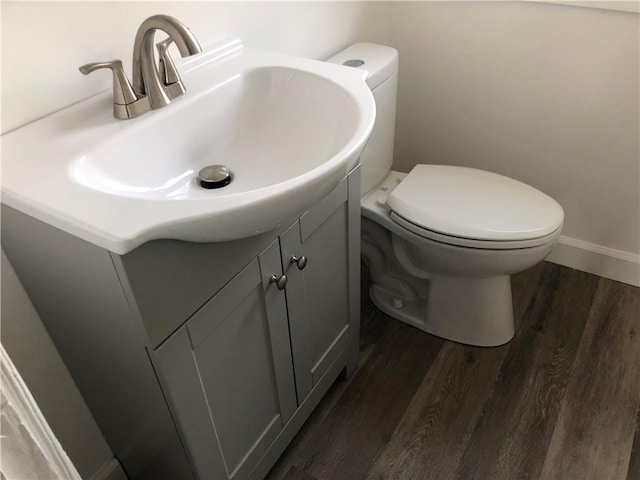 bathroom with vanity, hardwood / wood-style floors, and toilet