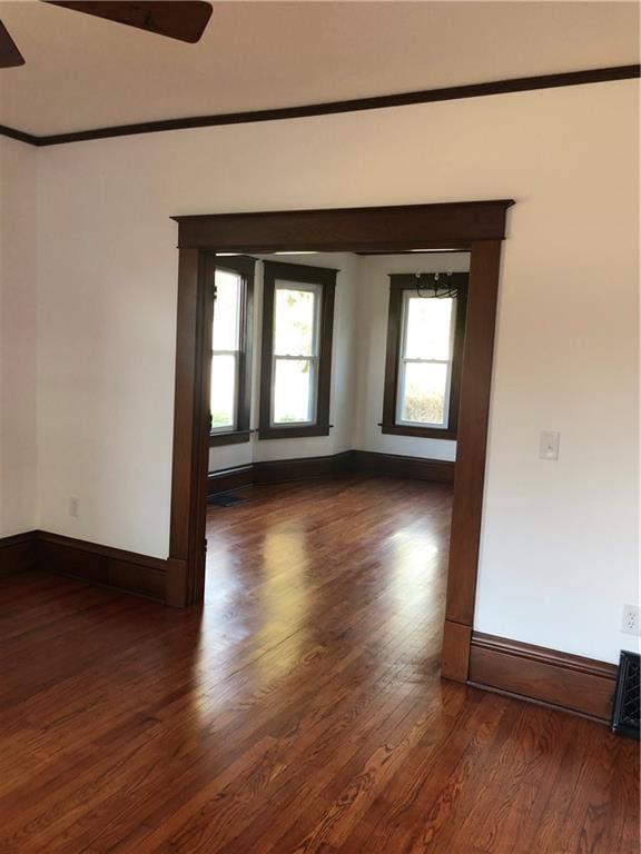 spare room with ceiling fan and dark hardwood / wood-style flooring