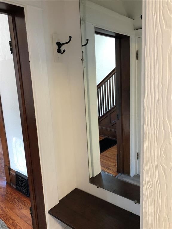 corridor featuring a wealth of natural light and hardwood / wood-style flooring