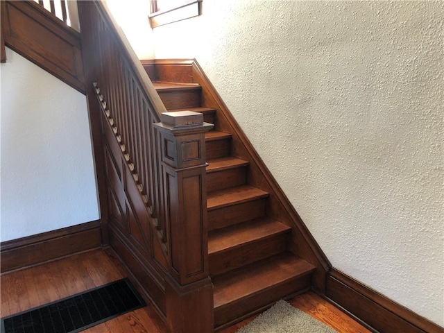 stairs featuring hardwood / wood-style floors