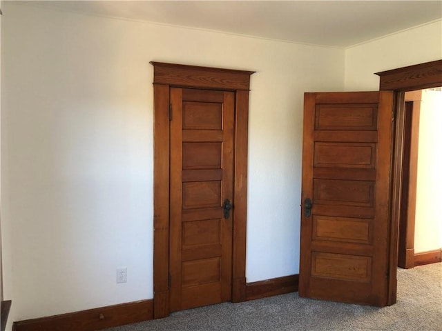 unfurnished bedroom featuring dark colored carpet