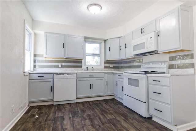 kitchen featuring white appliances, a textured ceiling, dark hardwood / wood-style flooring, white cabinetry, and decorative backsplash