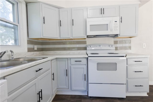 kitchen with white cabinets, dark hardwood / wood-style floors, and white appliances