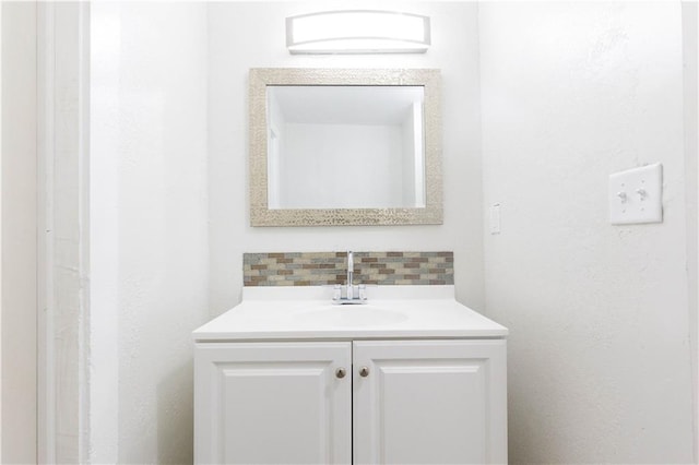 bathroom featuring vanity and decorative backsplash