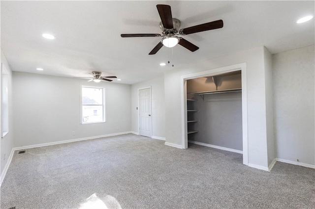 unfurnished bedroom with light colored carpet, a closet, and ceiling fan