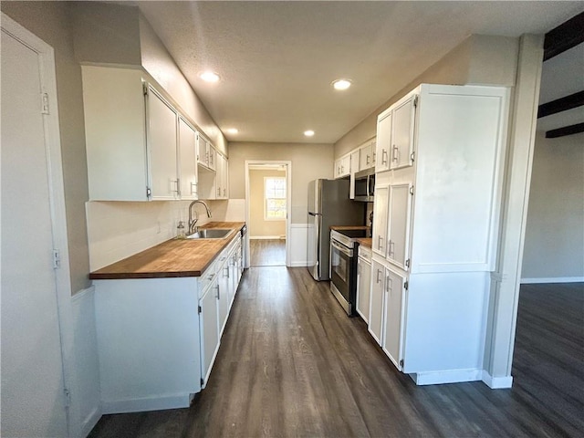 kitchen featuring white cabinetry, sink, and appliances with stainless steel finishes