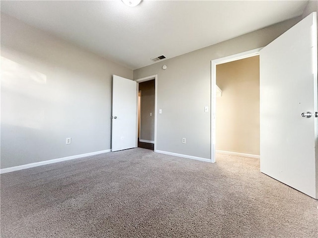 unfurnished room featuring carpet