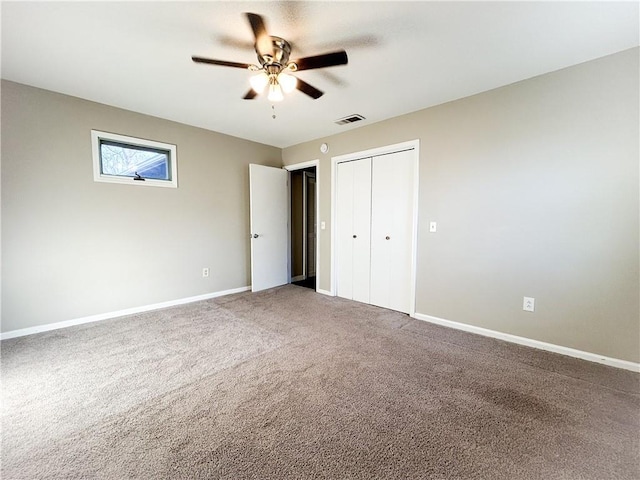 unfurnished bedroom featuring carpet, a closet, and ceiling fan