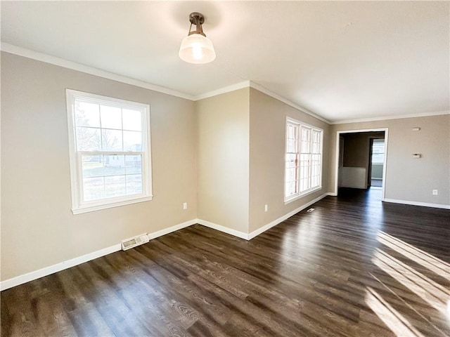 empty room featuring dark hardwood / wood-style floors and crown molding