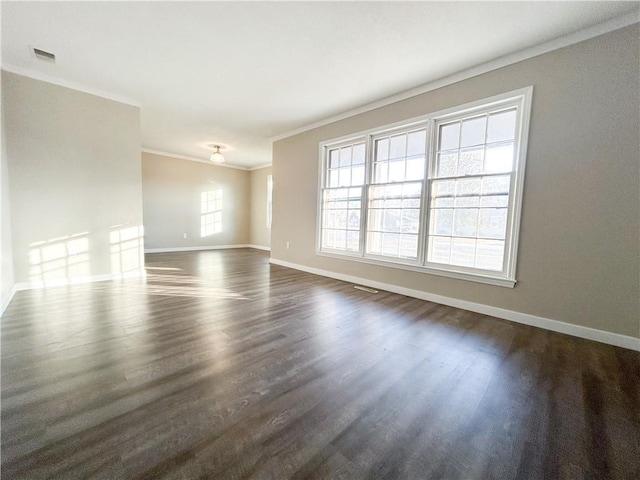 unfurnished room featuring a wealth of natural light, dark hardwood / wood-style flooring, and ornamental molding