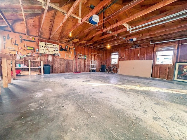 garage with a workshop area and a garage door opener