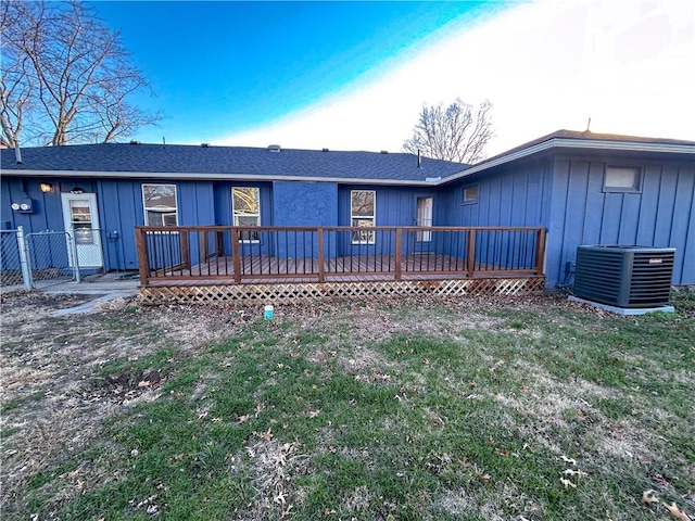 rear view of house with a wooden deck, a lawn, and central air condition unit