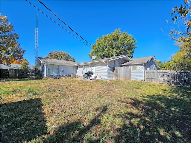 back of property with a patio area and a lawn