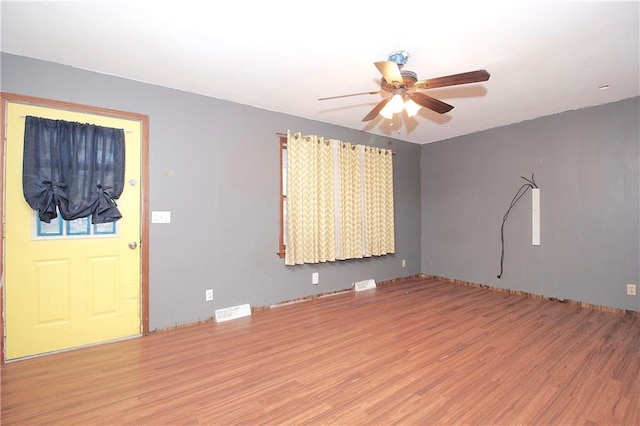 empty room with ceiling fan and wood-type flooring