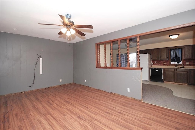 spare room with ceiling fan and light hardwood / wood-style floors