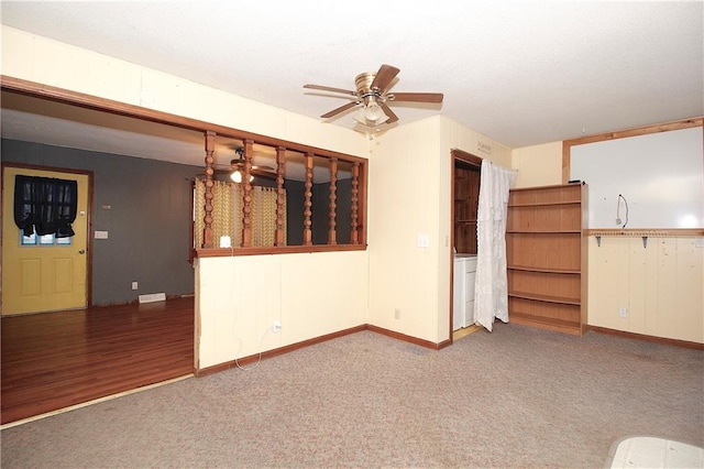 unfurnished living room featuring ceiling fan and carpet