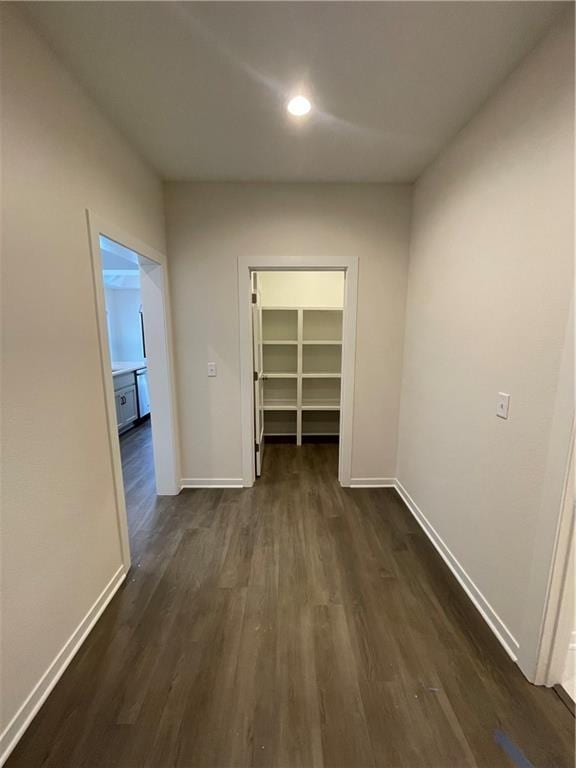 corridor featuring dark wood-type flooring