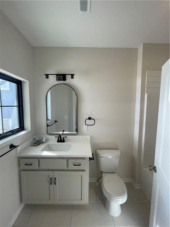 full bathroom featuring tile patterned flooring, vanity, bathing tub / shower combination, and toilet