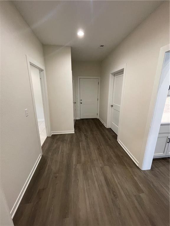 corridor with dark hardwood / wood-style floors