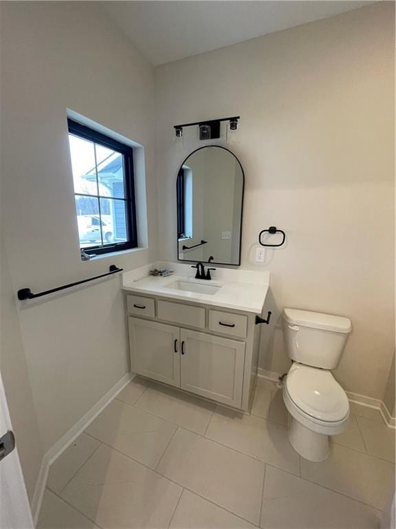 bathroom with vanity, tile patterned flooring, and toilet