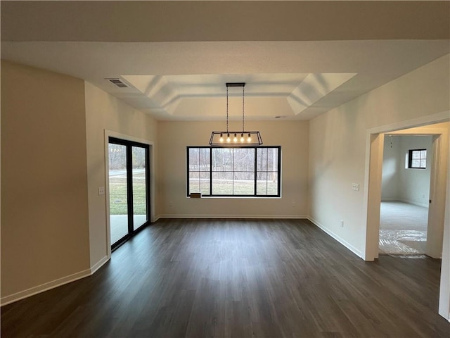 spare room with dark hardwood / wood-style floors and a tray ceiling