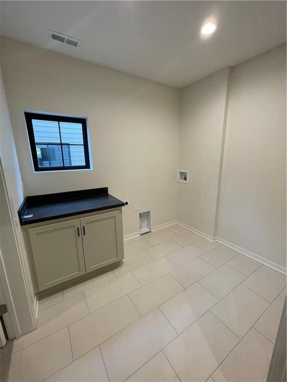 laundry room with washer hookup and cabinets