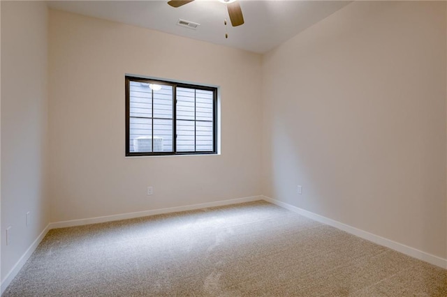 spare room with baseboards, a ceiling fan, and carpet