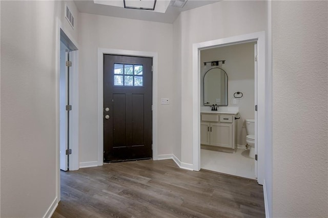 entryway featuring baseboards, dark wood-style floors, and visible vents