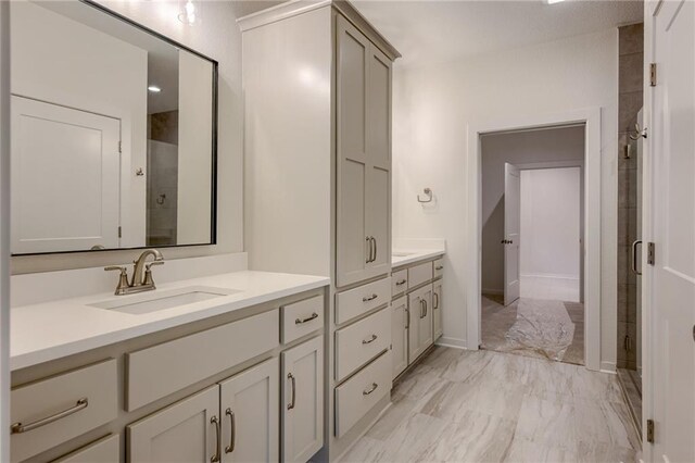 bathroom featuring vanity, a stall shower, and marble finish floor