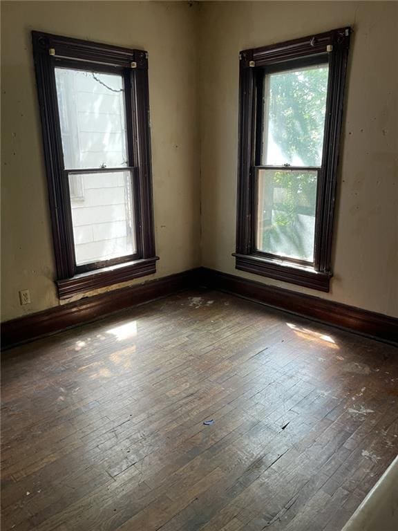 spare room featuring dark wood-type flooring