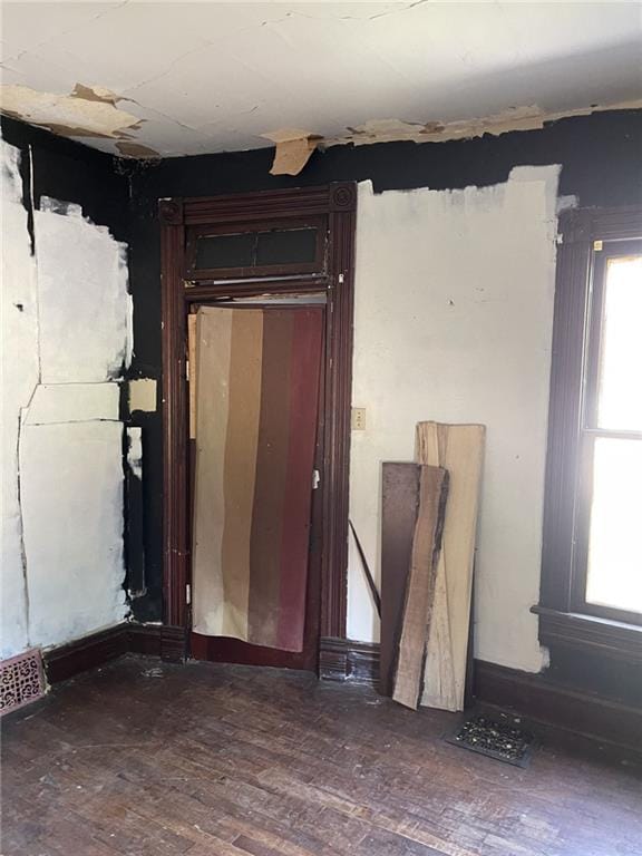 unfurnished room featuring dark wood-type flooring