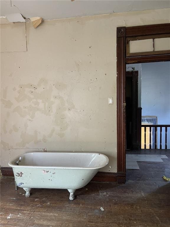 bathroom featuring hardwood / wood-style flooring and a bath