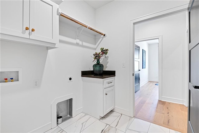 washroom featuring cabinets, light hardwood / wood-style flooring, washer hookup, and electric dryer hookup