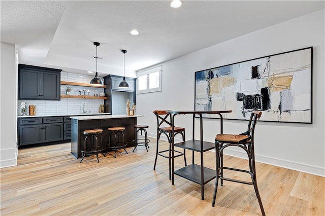 interior space with indoor bar and light wood-type flooring