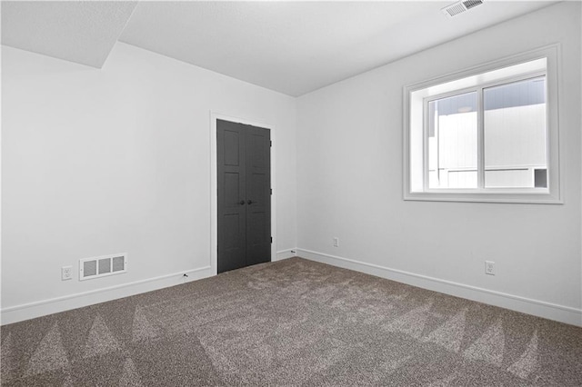 unfurnished room with carpet flooring