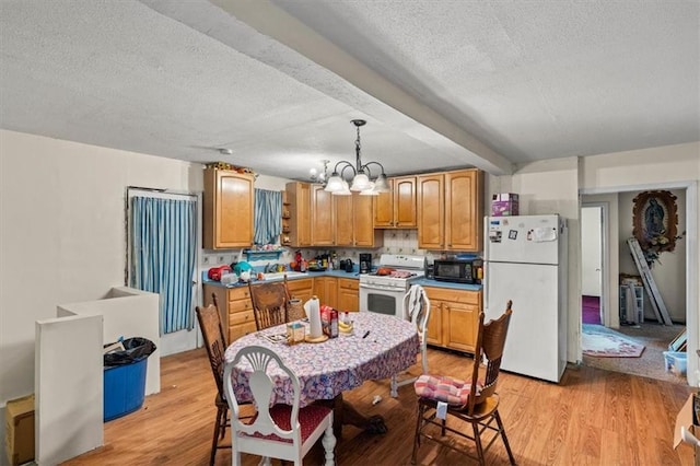 kitchen with beam ceiling, white appliances, a notable chandelier, decorative light fixtures, and light hardwood / wood-style floors