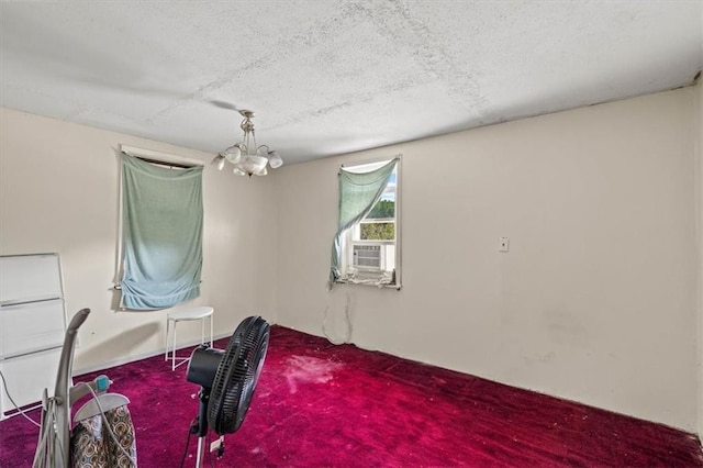 interior space featuring carpet floors and a chandelier