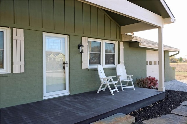 view of exterior entry featuring a wooden deck