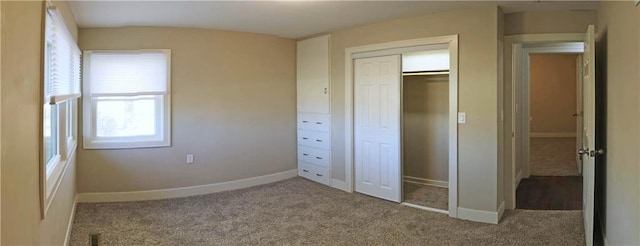 unfurnished bedroom featuring carpet and a closet