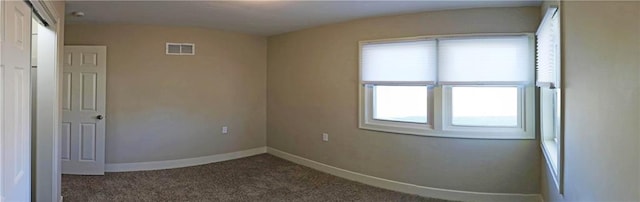 carpeted empty room with plenty of natural light