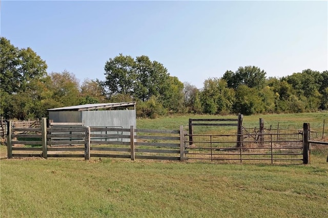 view of yard featuring a rural view and an outbuilding