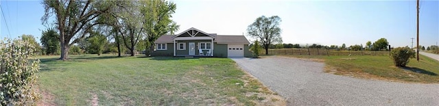 view of front of property featuring a front lawn and a garage