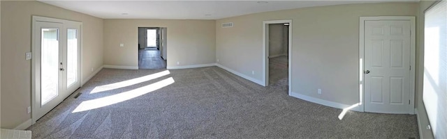 spare room with french doors and dark carpet