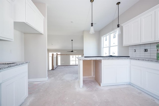 kitchen featuring white cabinets and ceiling fan