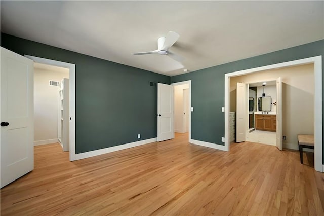 unfurnished bedroom featuring light hardwood / wood-style floors, ceiling fan, and ensuite bathroom